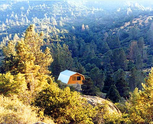 The cabin nestled in its site